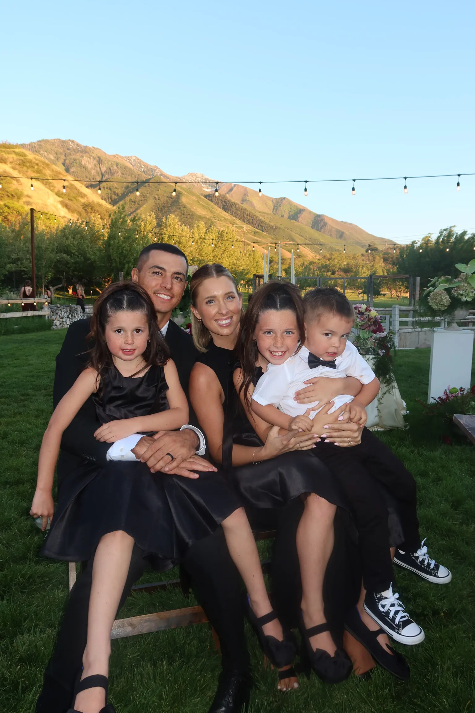Steele and Cass McBride dressed up with their three kids at golden hour